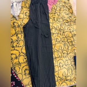 Black elasticated pants with white threaded stripes and pockets